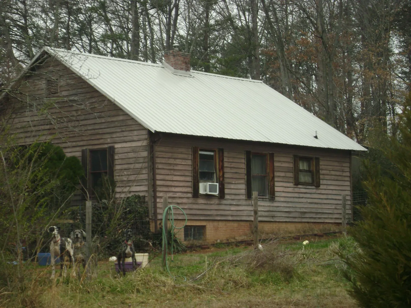 White metal roof on an old wood sided farmhouse, from a Metal Roof Installation job in Chagrin Falls